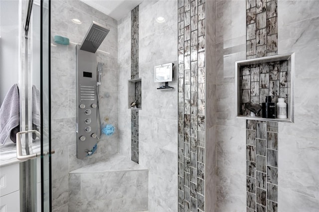 bathroom featuring a shower with shower door