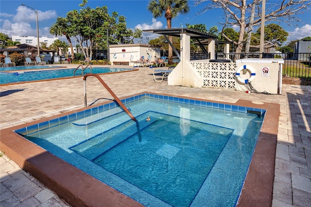 view of swimming pool with a gazebo and a hot tub