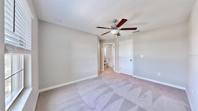 empty room with light carpet and ceiling fan