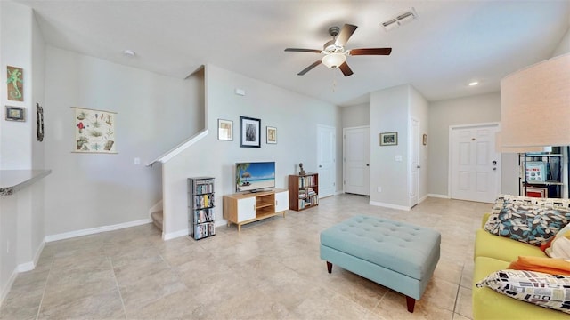 living area featuring stairs, baseboards, a ceiling fan, and visible vents