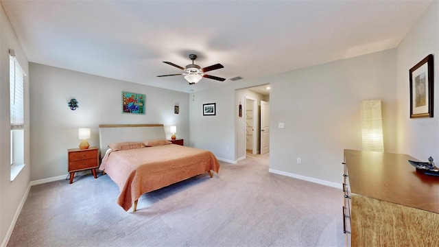 bedroom with ceiling fan, light carpet, baseboards, and visible vents