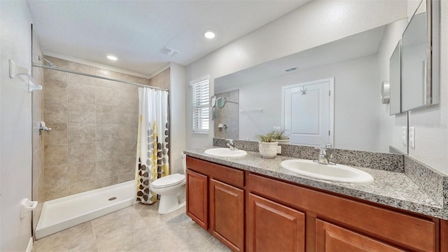 full bathroom with toilet, a tile shower, and a sink