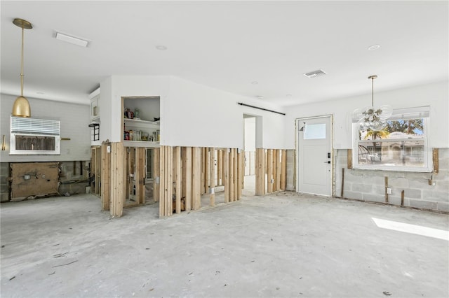 unfurnished living room with concrete floors and a barn door