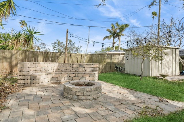 view of patio / terrace with a storage unit and an outdoor fire pit