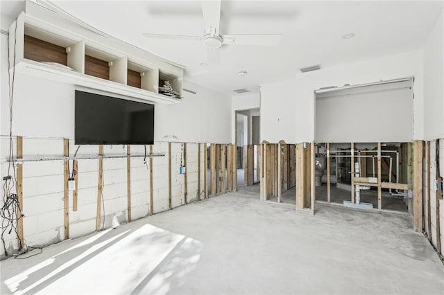 miscellaneous room with concrete flooring and ceiling fan