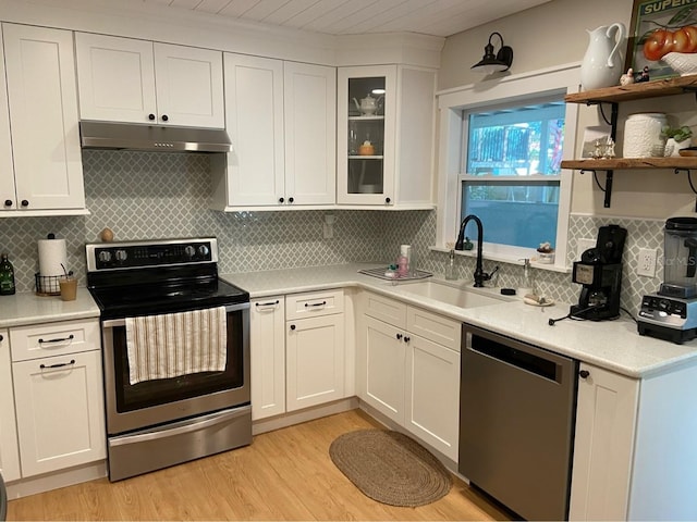 kitchen featuring appliances with stainless steel finishes, sink, and white cabinets