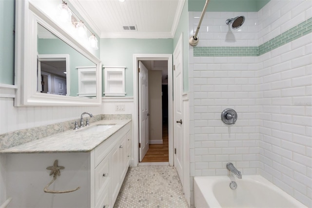 bathroom featuring crown molding, tile patterned floors, vanity, and tiled shower / bath