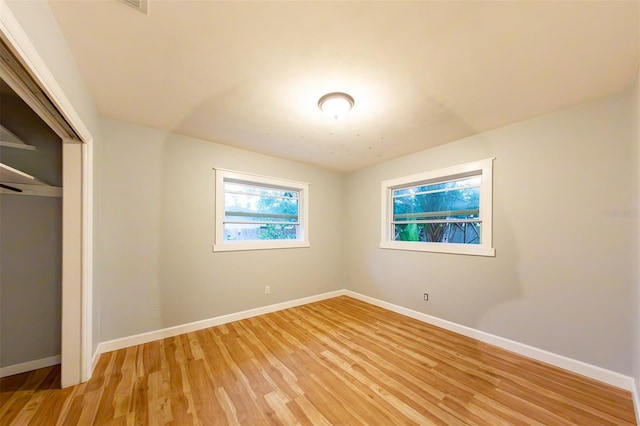 unfurnished bedroom with light hardwood / wood-style floors and a closet