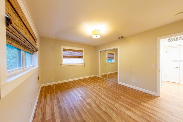 unfurnished room with light wood-type flooring