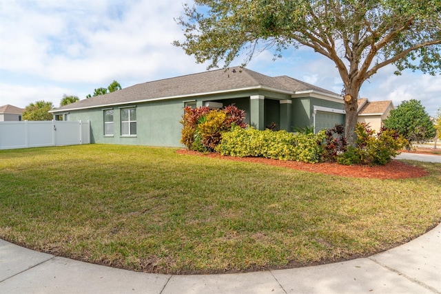 view of side of property with a garage and a lawn