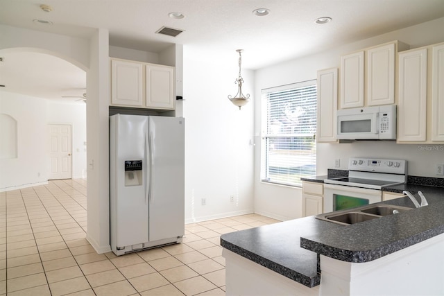 kitchen featuring light tile patterned flooring, decorative light fixtures, sink, ceiling fan, and white appliances