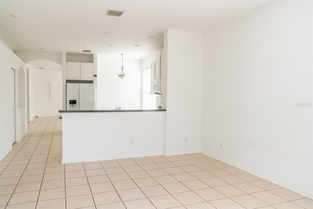 kitchen with white cabinetry, white appliances, pendant lighting, and light tile patterned floors