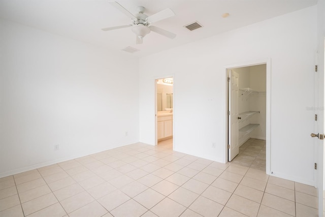 tiled spare room with ceiling fan