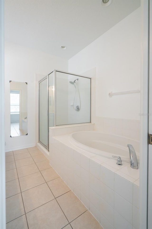 bathroom with tile patterned flooring and separate shower and tub