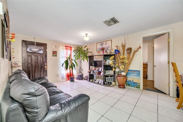 living room with tile patterned floors and a textured ceiling