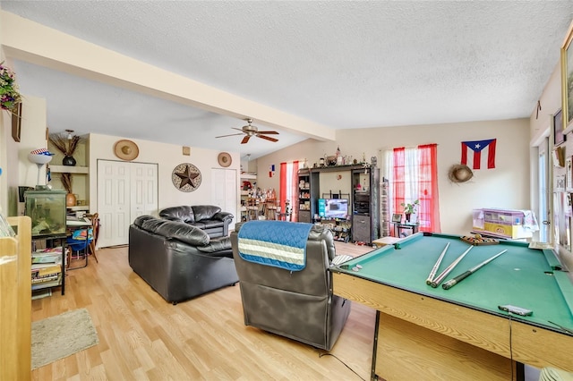 game room with hardwood / wood-style flooring, ceiling fan, lofted ceiling with beams, a textured ceiling, and pool table