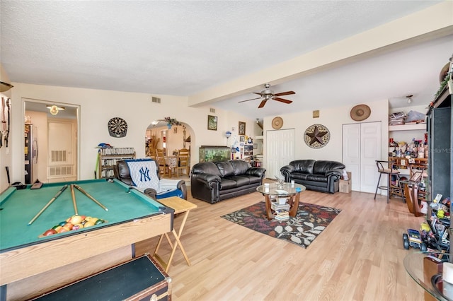 rec room featuring beamed ceiling, pool table, hardwood / wood-style floors, and a textured ceiling