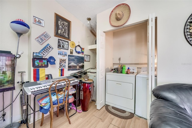 interior space featuring light hardwood / wood-style floors, independent washer and dryer, and a textured ceiling