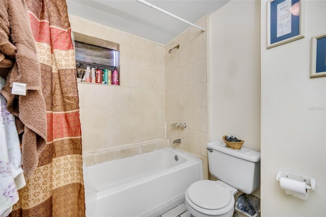 bathroom with tiled shower / bath combo and toilet