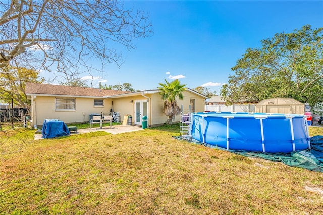 rear view of house featuring a lawn and a patio area