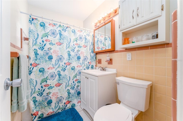 bathroom with tile walls, vanity, walk in shower, toilet, and tile patterned floors