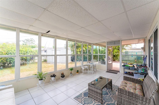 sunroom featuring a paneled ceiling