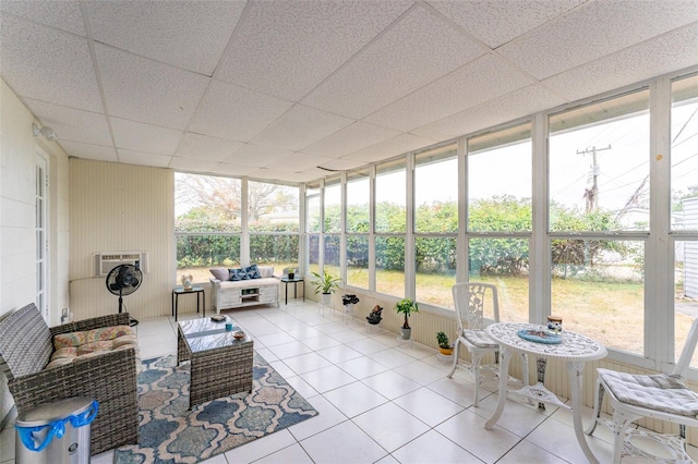 sunroom featuring a wealth of natural light and a drop ceiling