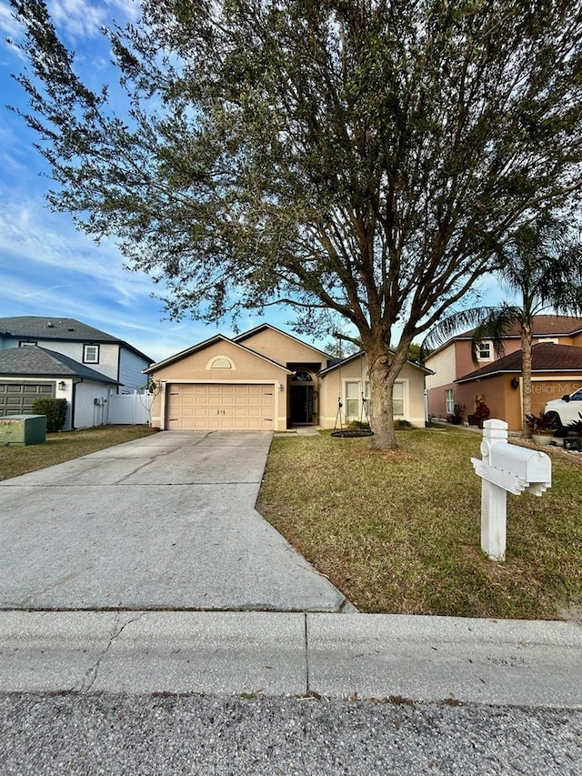 single story home featuring a garage and a front yard