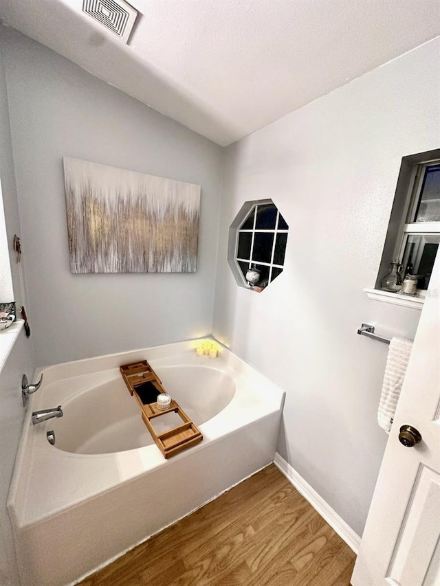 bathroom featuring hardwood / wood-style floors and a bathtub