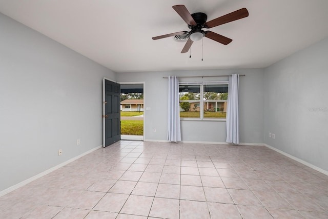 tiled empty room featuring ceiling fan