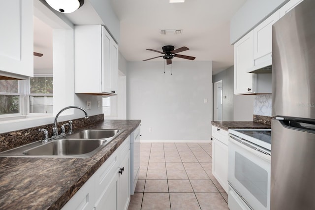 kitchen featuring white cabinetry, sink, white appliances, and light tile patterned floors