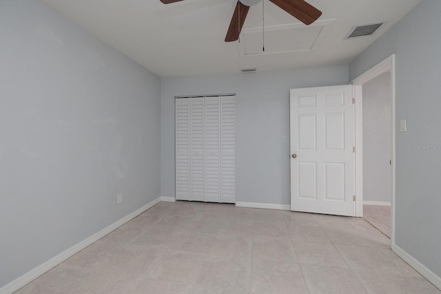 tiled spare room featuring ceiling fan