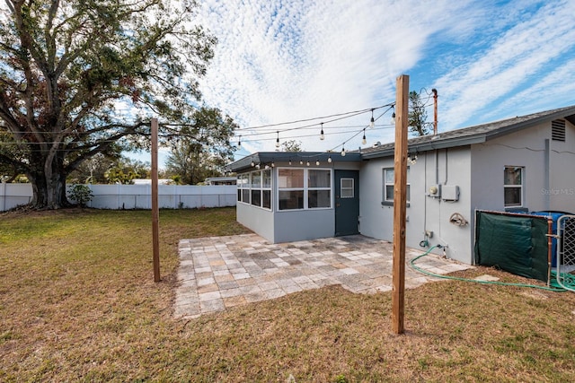 view of yard with a sunroom and a patio area