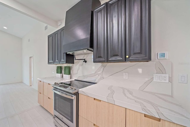 kitchen featuring stainless steel electric range, custom exhaust hood, beamed ceiling, and light brown cabinets