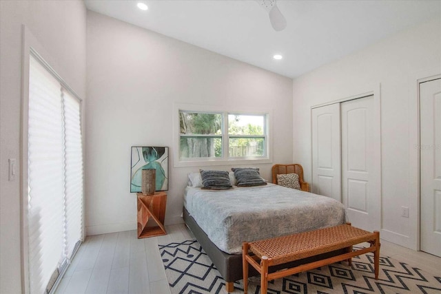 bedroom with ceiling fan, lofted ceiling, light hardwood / wood-style floors, and a closet