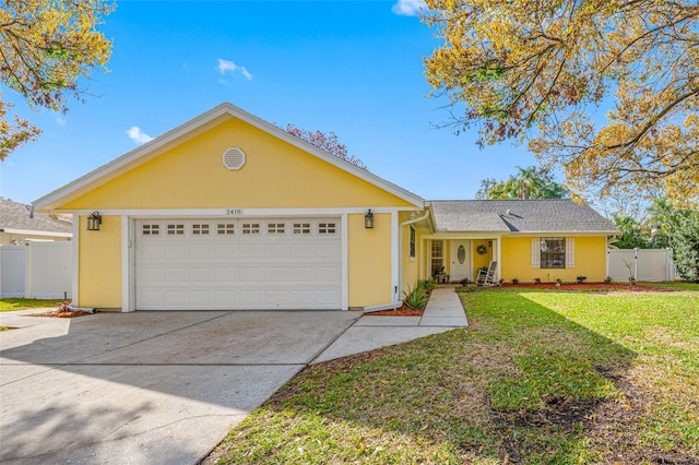 single story home featuring a garage and a front yard