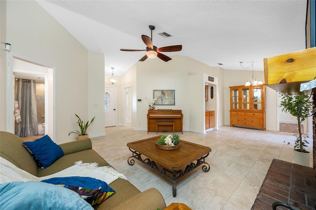 living room featuring lofted ceiling, ceiling fan with notable chandelier, and a textured ceiling