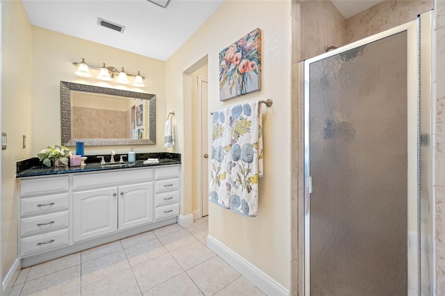 bathroom with vanity, tile patterned flooring, and a shower with shower door