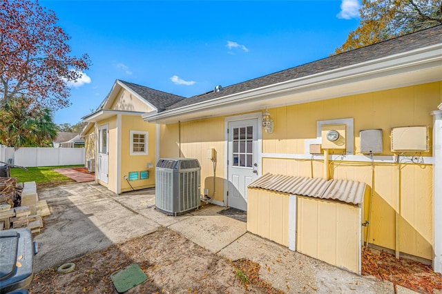 rear view of property featuring central AC unit and a patio area