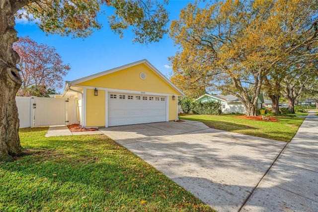 view of front of house with a garage and a front lawn