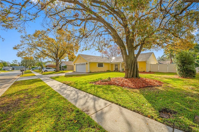 ranch-style home featuring a garage and a front yard