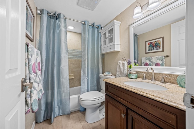 full bathroom with wood-type flooring, toilet, shower / tub combo, and vanity