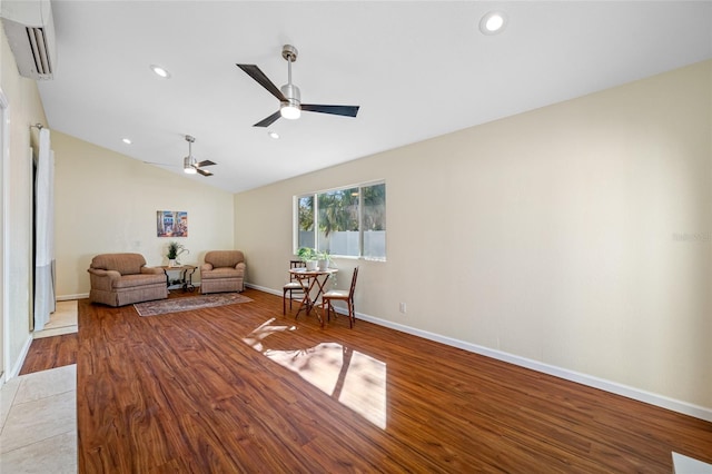 unfurnished room featuring vaulted ceiling, ceiling fan, a wall mounted air conditioner, and light hardwood / wood-style floors