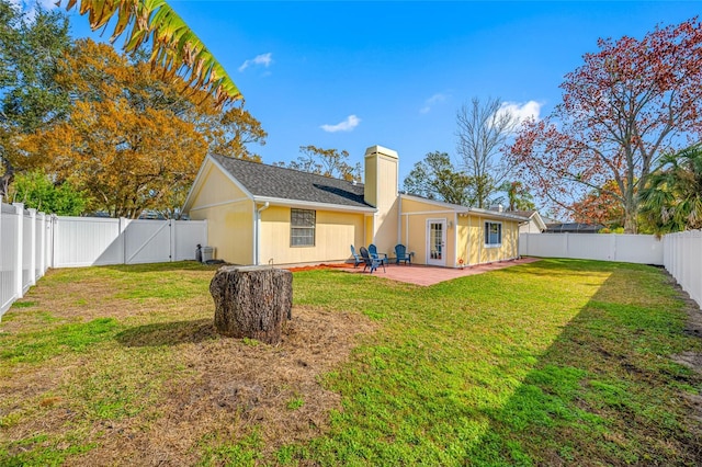 rear view of house featuring a patio and a lawn