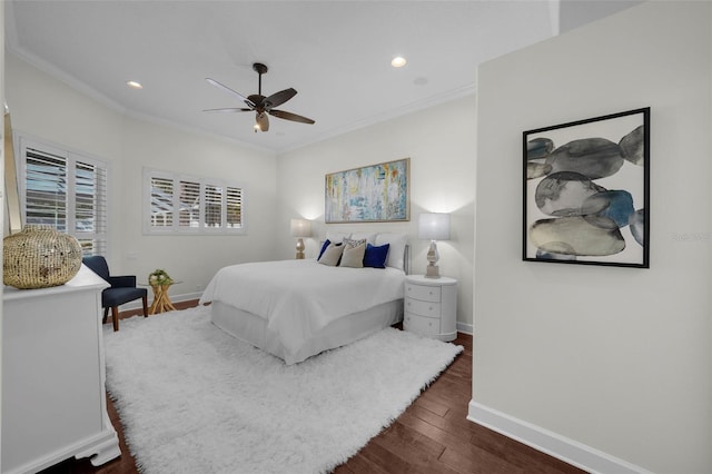 bedroom with crown molding, dark hardwood / wood-style floors, and ceiling fan