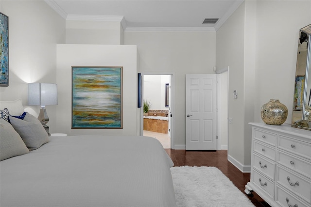 bedroom with crown molding, dark wood-type flooring, and ensuite bathroom