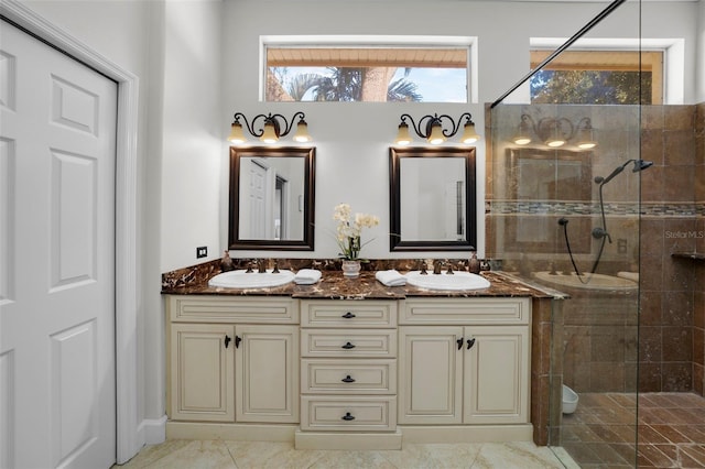 bathroom with a shower with door and vanity