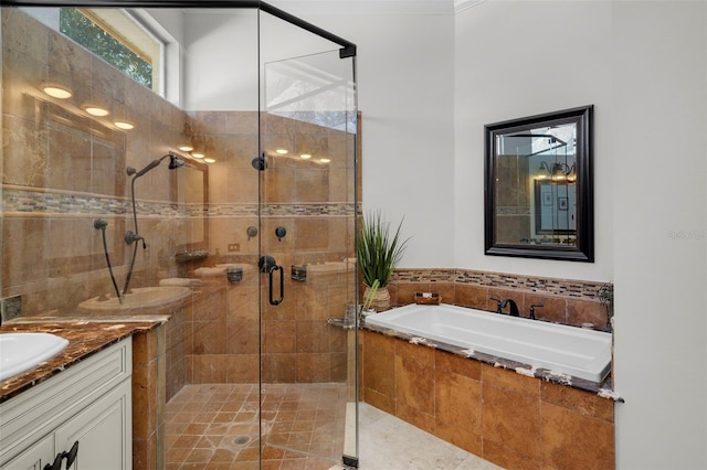 bathroom featuring vanity and independent shower and bath