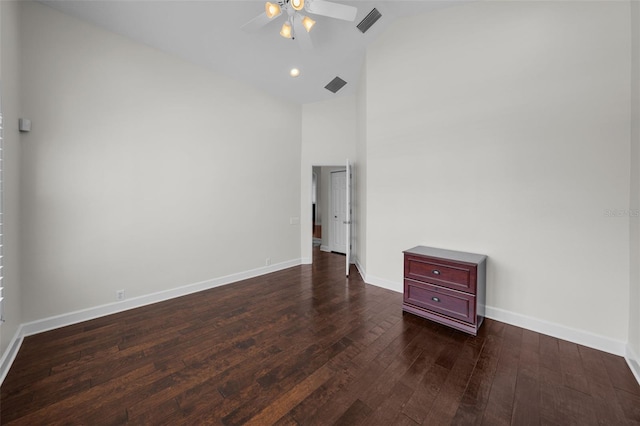 unfurnished bedroom featuring ceiling fan, dark wood-type flooring, and high vaulted ceiling