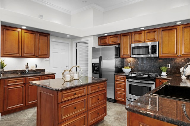 kitchen featuring stainless steel appliances, a kitchen island, sink, and dark stone counters